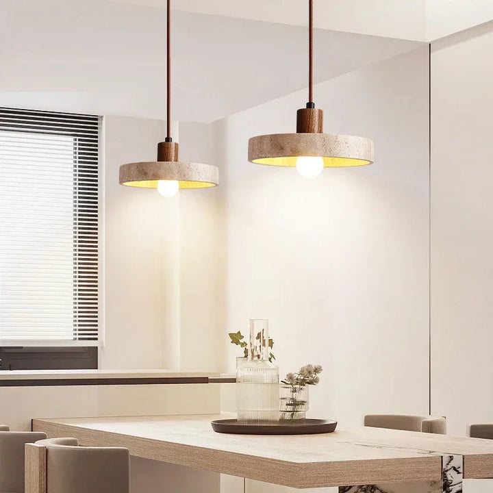 Dining room with two natural stone pendant lights illuminating wooden table