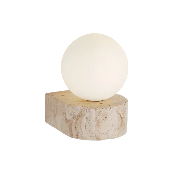 Table lamp with a spherical white bulb on a natural wood base against a white background