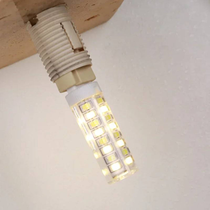 Close-up of KLOT wall lamp G9 LED bulb fitting inside yellow travertine stone base