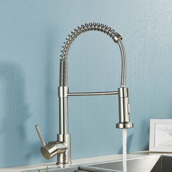 Stainless steel kitchen faucet with a blue wall background