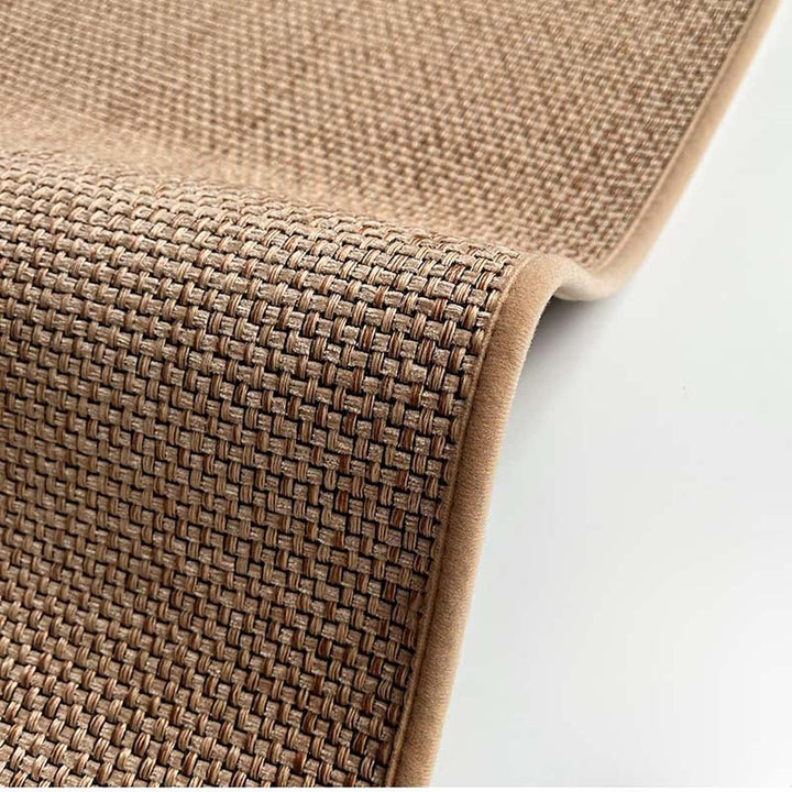 Close-up of a woven brown kitchen mat on a white background