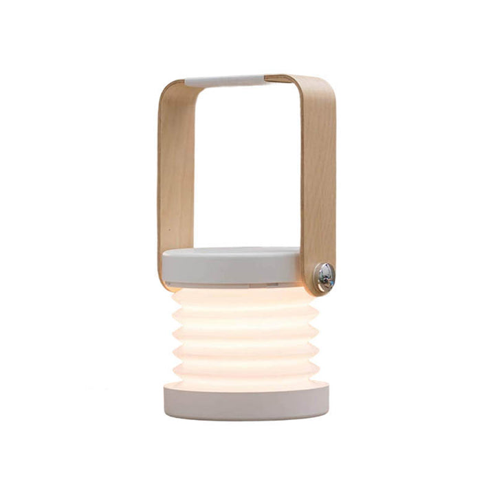 LYKT rechargeable LED lantern with wooden handle and foldable base, warm white light, ideal for desk or bedside use.