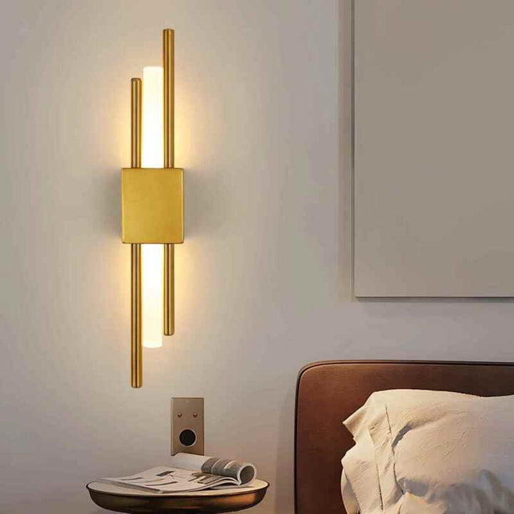 Warm gold LED wall lamp beside bed creating cozy bedroom ambience