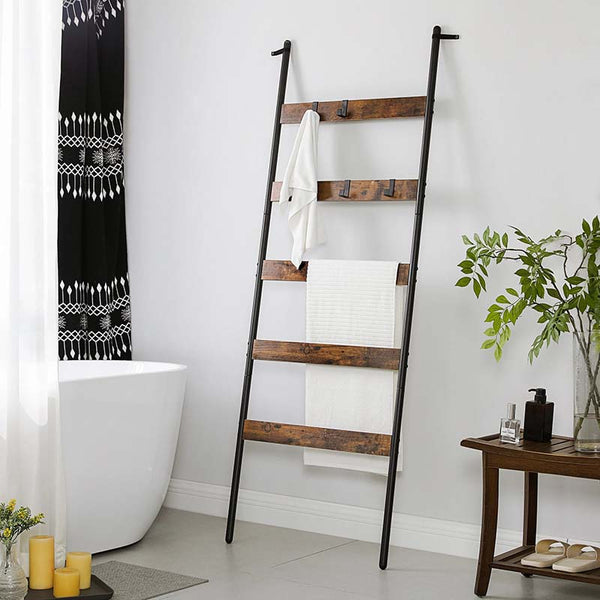 Wooden towel ladder with white towels in a bathroom setting