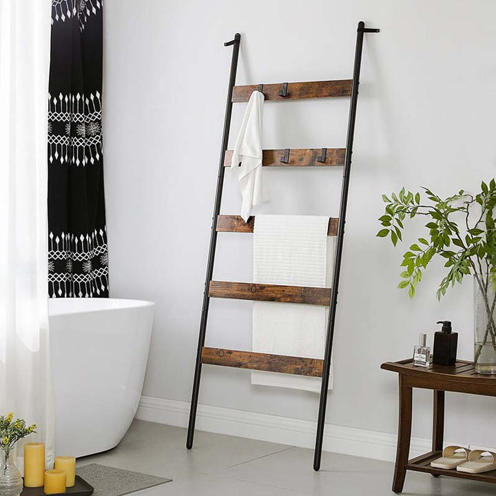 Wooden towel ladder with white towels in a bathroom setting