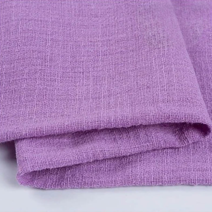 Folded lavender - purple cotton napkin for Weddings and Elegant uk Dining Decor on the white table.