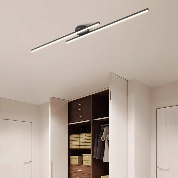Ceiling light fixture in a modern interior setting with an open wardrobe.