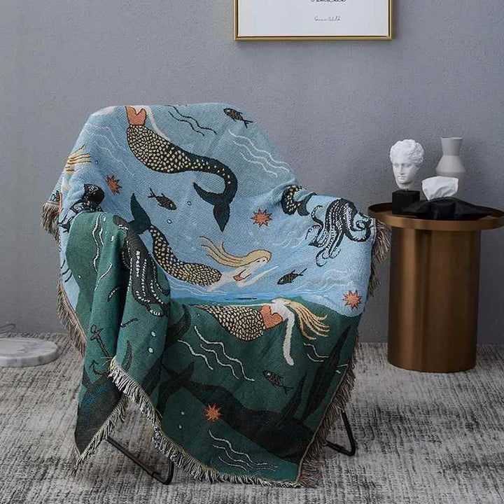 Mermaid-themed blanket draped over a chair in a room, a Nordic-inspired piece for modern interiors.