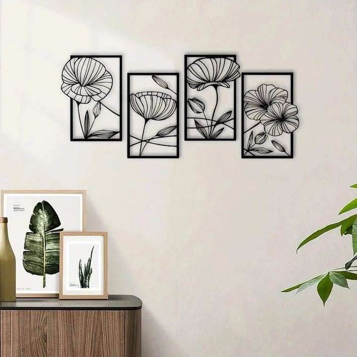 Set of floral metal wall art pieces on a light gray wall with framed botanical prints below.