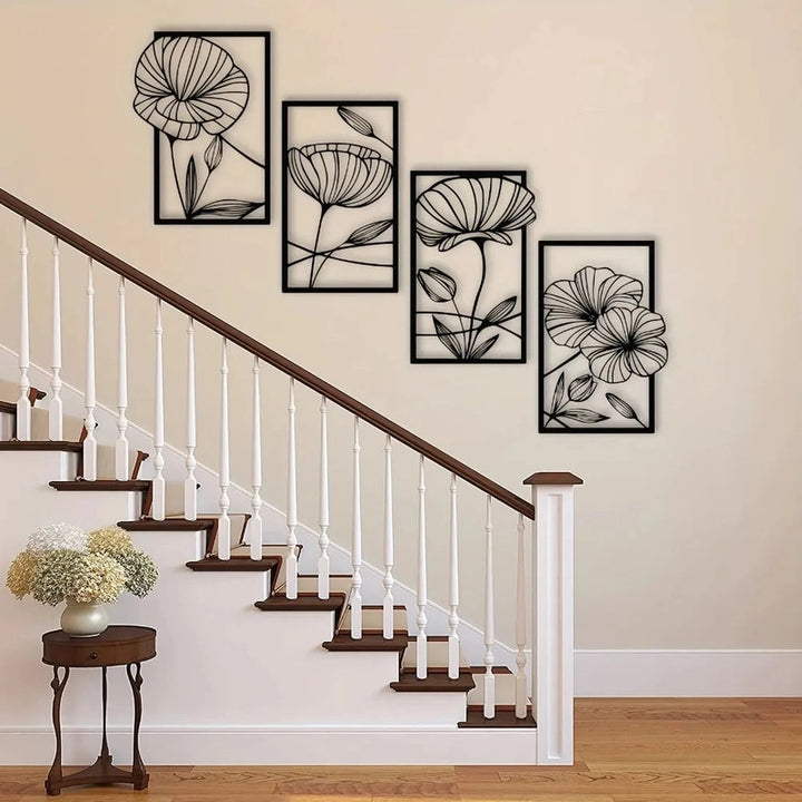 Floral wall art above a staircase with a side table and flowers.