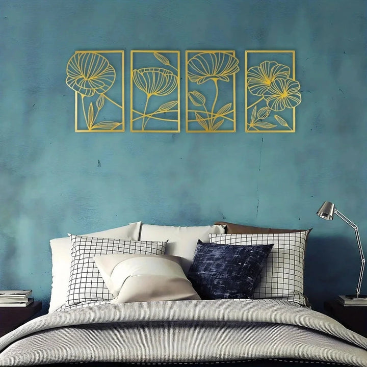 Decorative floral wall art on a blue wall above a bed with pillows.