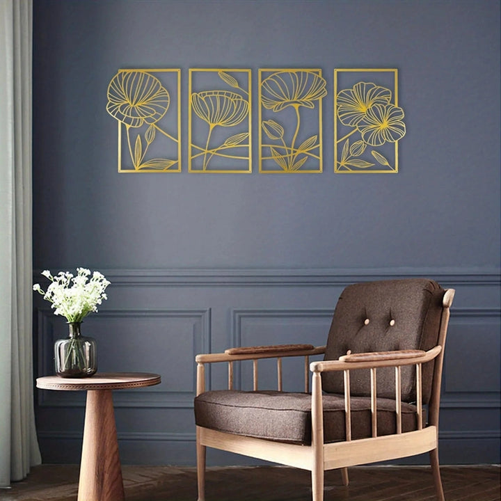 Decorative wall art with floral designs on a blue wall above a brown armchair.