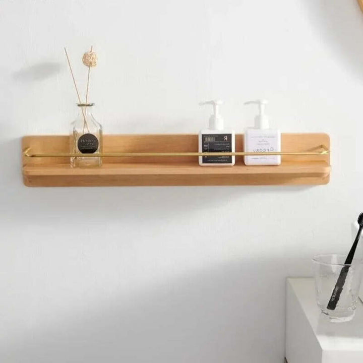 Wall-mounted bamboo shelf with gold guard rail, ideal for bathroom or vanity organization