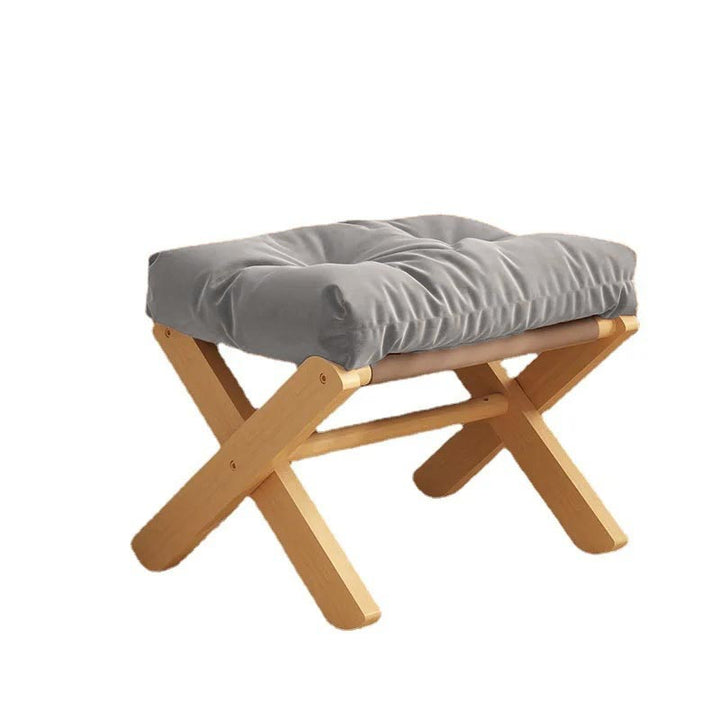 Stand-alone grey padded ottoman with wooden frame, stylish and versatile for footrest or seat in modern Nordic décor schemes.