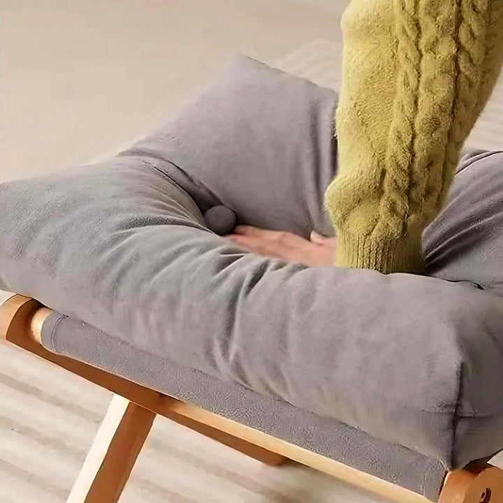 Hand pressing deep into soft grey cushion, demonstrating the plush high-resilience filling of the minimalist wooden ottoman