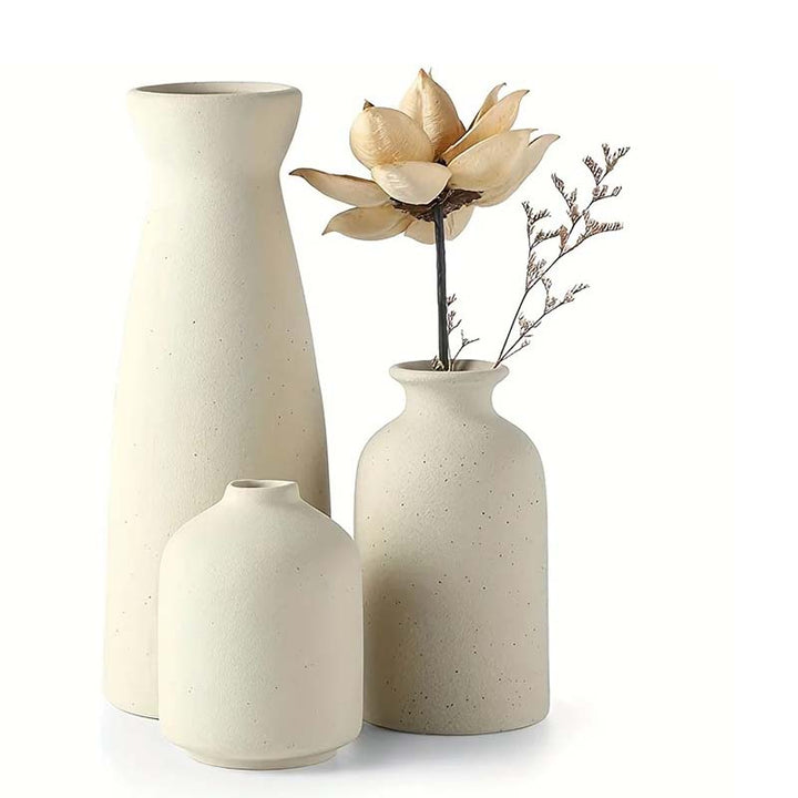 Set of three ceramic vases on a white background