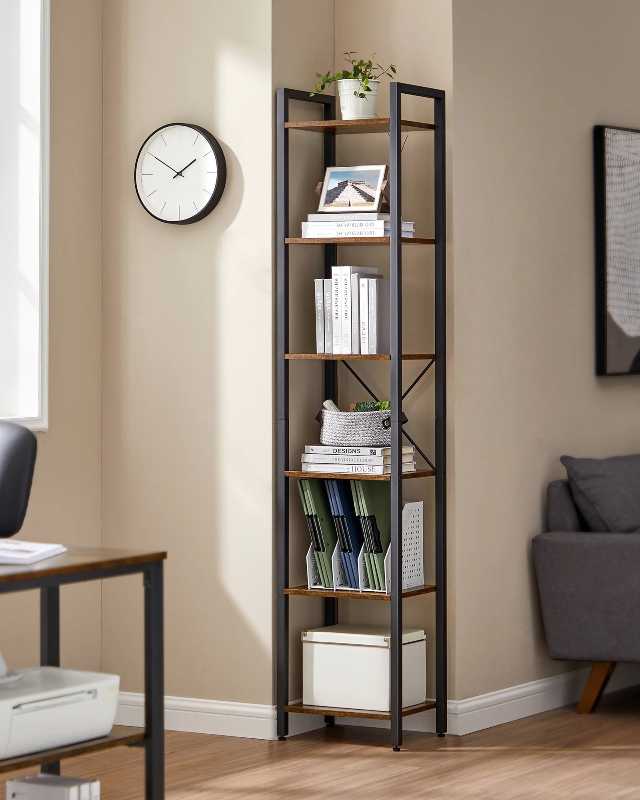 Tall bookshelf with books and decor in a room with a clock and sofa.