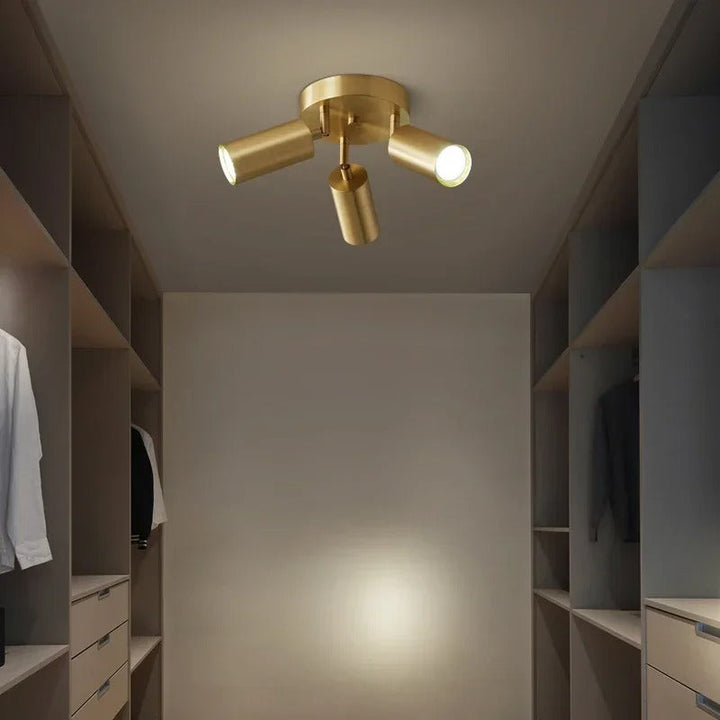 Gold ceiling light fixture in a modern interior setting