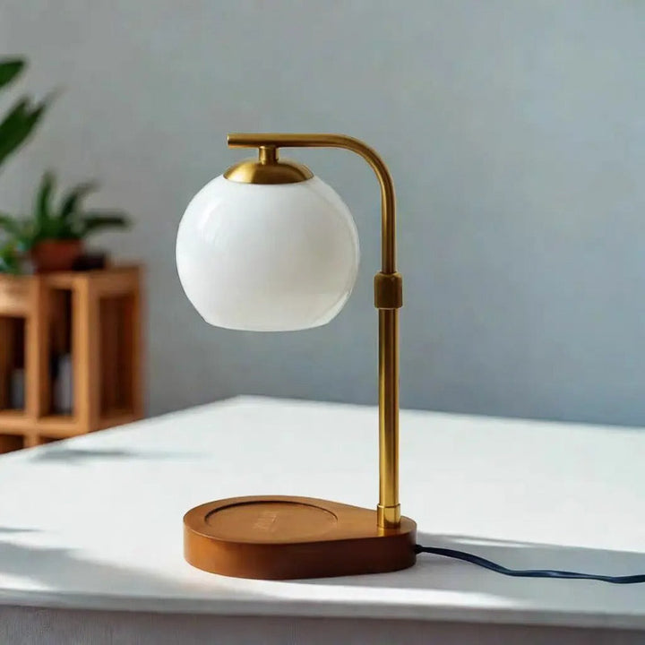 Table lamp with a white candle warmer on a white surface, blurred background