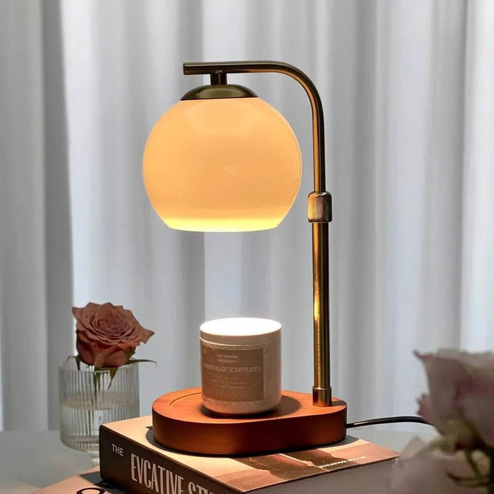 Table lamp with a candle warmer warm glow on a surface, with a blurred background