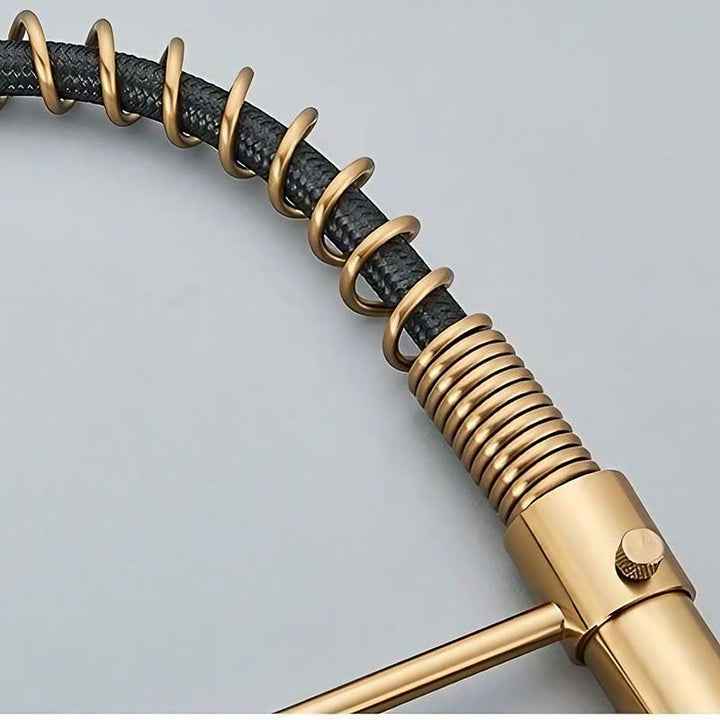 Gold and black coiled hose on a light gray background