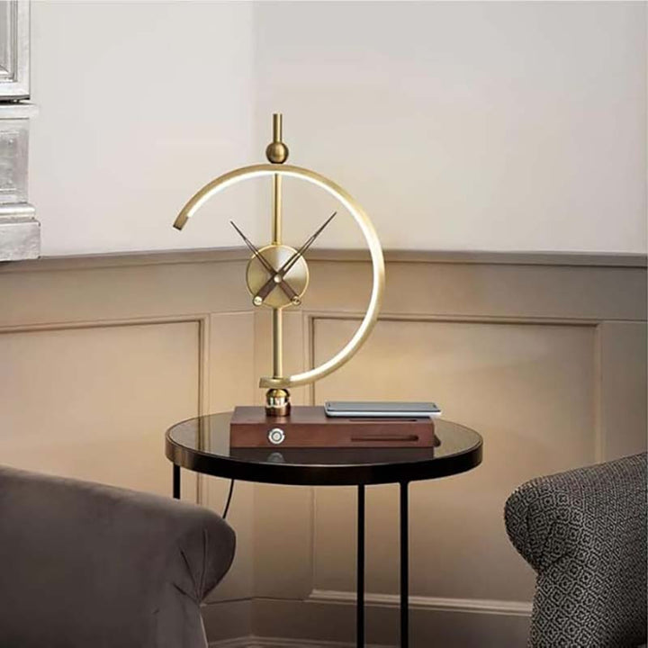 Modern table lamp with gold circular design on a side table in a room setting.