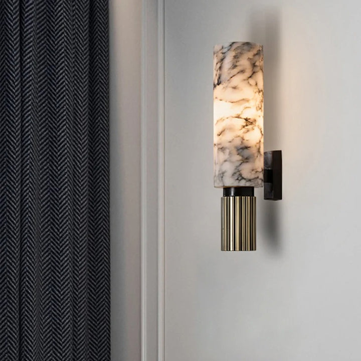 Vintage marble and brass wall lamp above sofa in luxury lounge, perfect for warm ambient UK living room lighting.