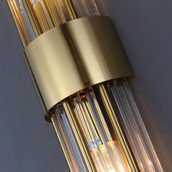 Close-up of gold stainless steel base and crystal rods on modern Nordic LED wall light for UK bedroom or hallway