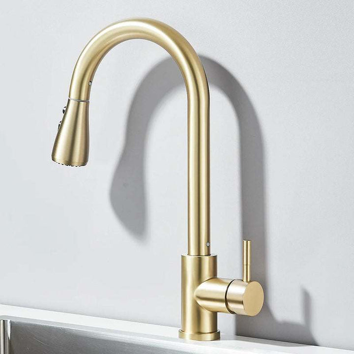 Brushed gold pull-out kitchen faucet with tall curved spout and minimalist handle.
