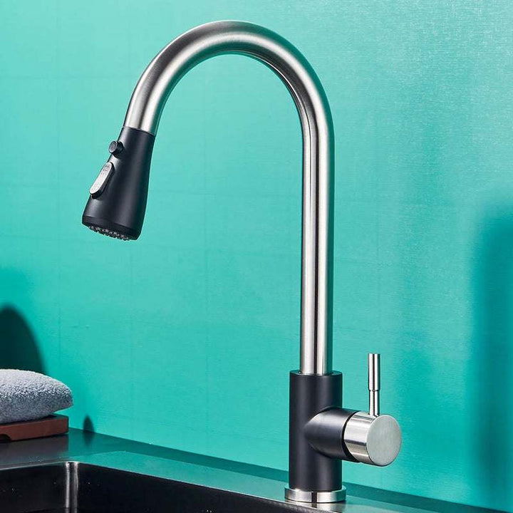Two-tone stainless steel and matte black pull-out kitchen faucet with curved spout.