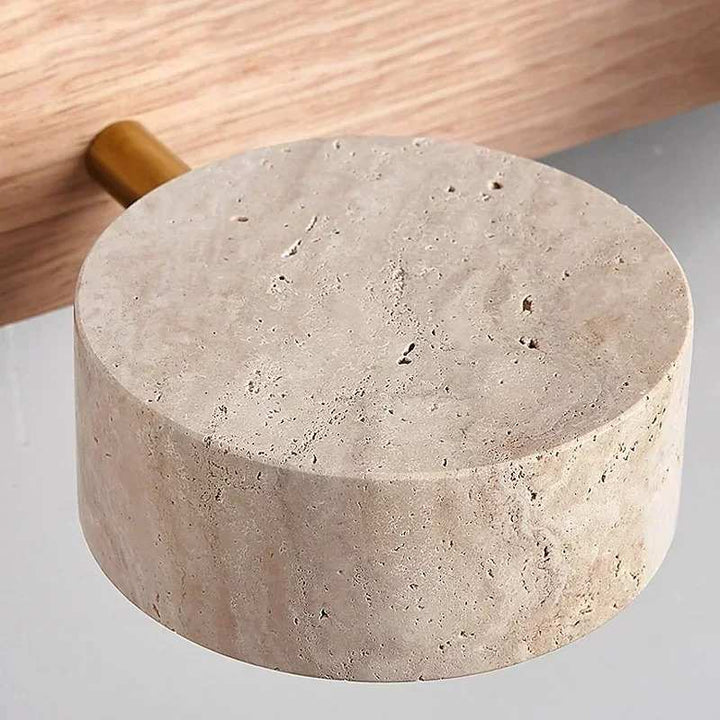 Round concrete block with a wooden handle on a light gray background