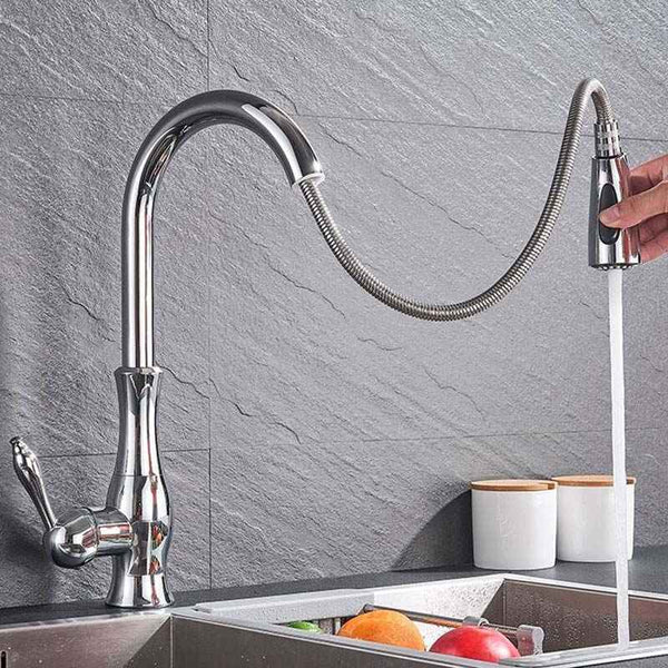 Chrome Pull-Out kitchen faucet with a flexible hose being used over a sink.