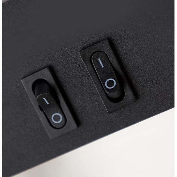 Two black toggle switches on a dark gray surface.