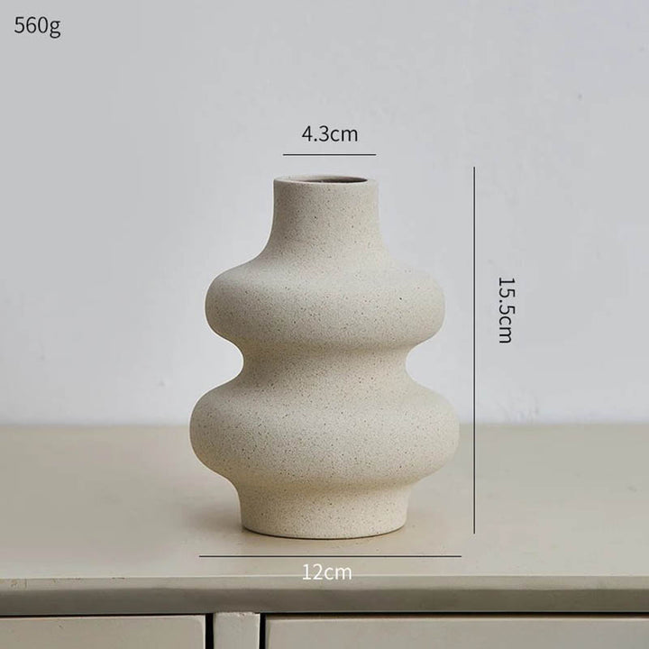 Modern minimalist ceramic vase with curved silhouette, neutral sand finish, Nordic Essentials UK home decor