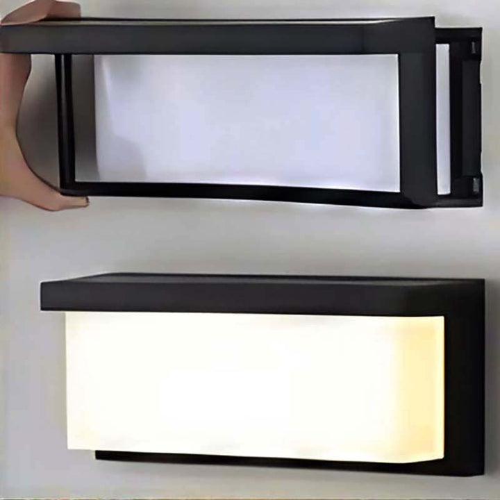 Nordic Essentials Motion Sensor Wall Light held to show modern black plastic LED design for outdoor use
