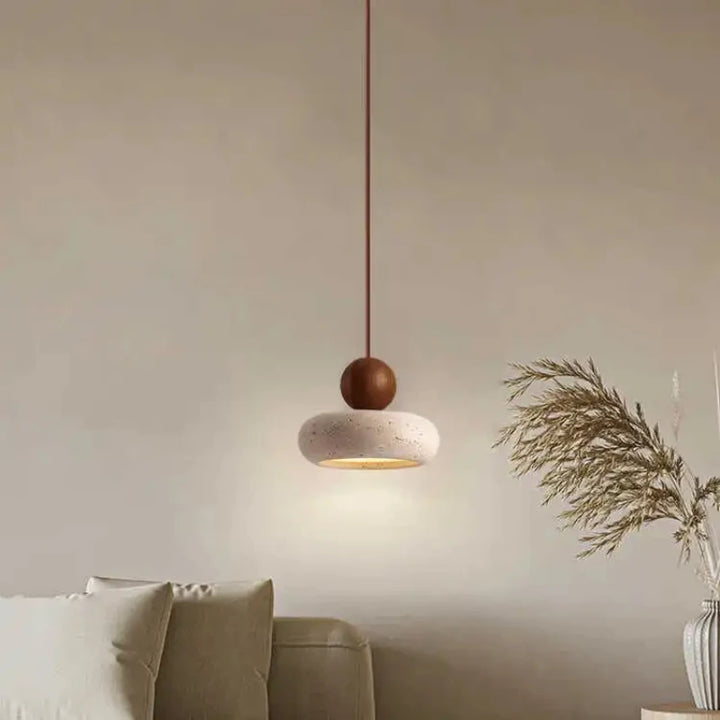 NATUR vintage pendant lamp with dark wood accent hanging above sofa in minimalist living room