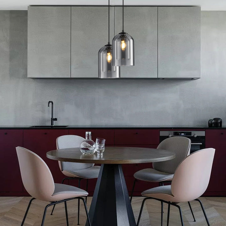Two smoked glass pendant lights over a round dining table