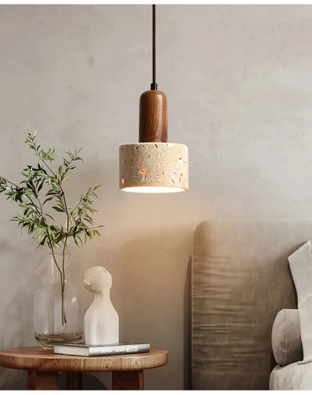 Natural Stone Pendant light fixture hanging above a table with decorative items in a room setting.
