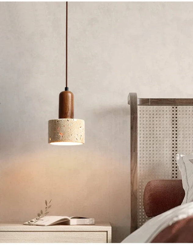 Natural Stone Pendant light fixture in a bedroom setting with a wooden base and concrete-like shade.