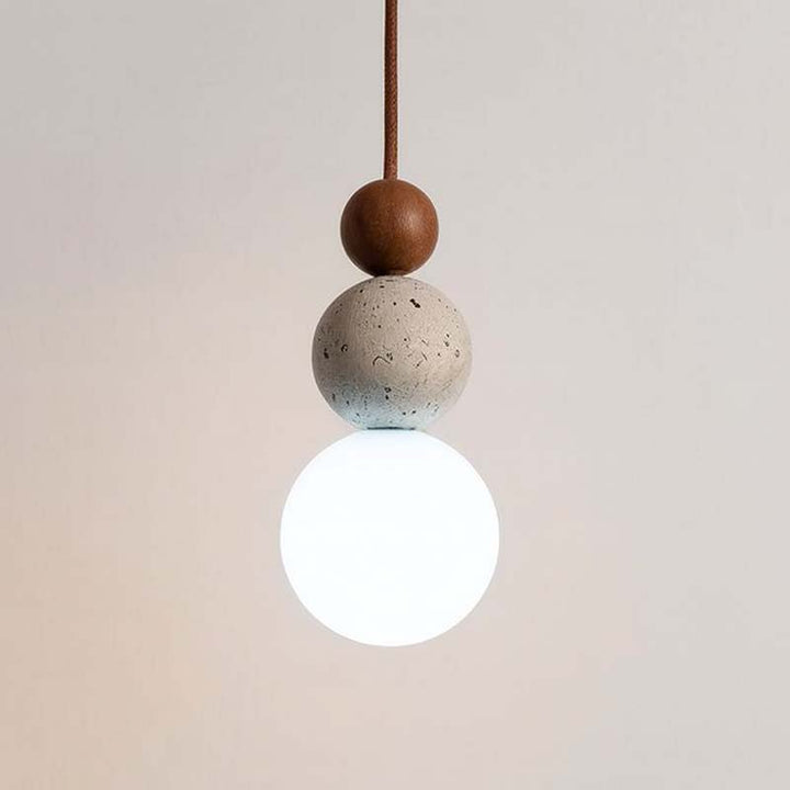 Minimalist pendant light with round concrete and wooden beads, featuring a white glass globe bulb, ideal for modern Scandinavian interiors.