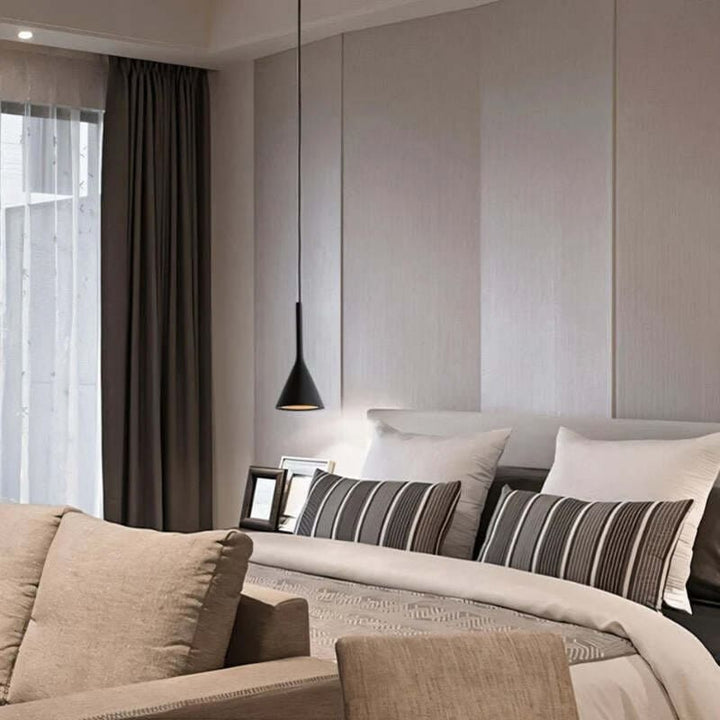Modern living room with beige sofa, striped cushions, and a pendant light.