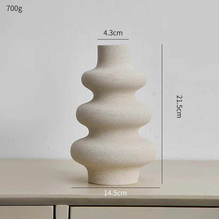 Tall modern ceramic vase with waved contour, natural sand tone, ideal for Scandinavian shelf styling