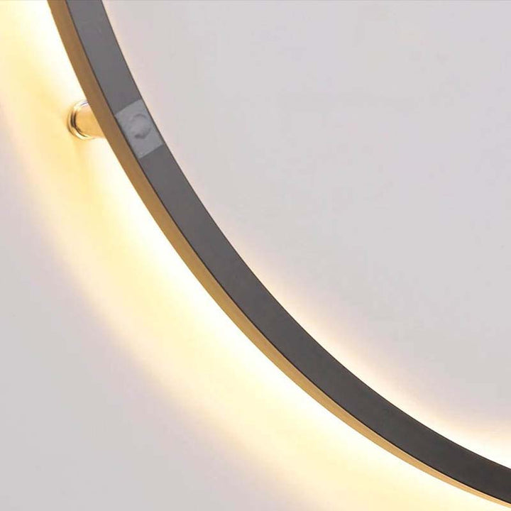 Close-up of USB-powered KRETS wall lamp showing smooth warm light detail and brushed metal finish
