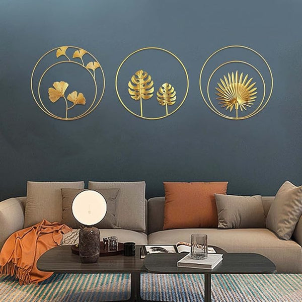 Trio of Ginkgo leaf metal wall art pieces in varying sizes (21cm, 24cm, 28cm) displayed in UK living room seeting