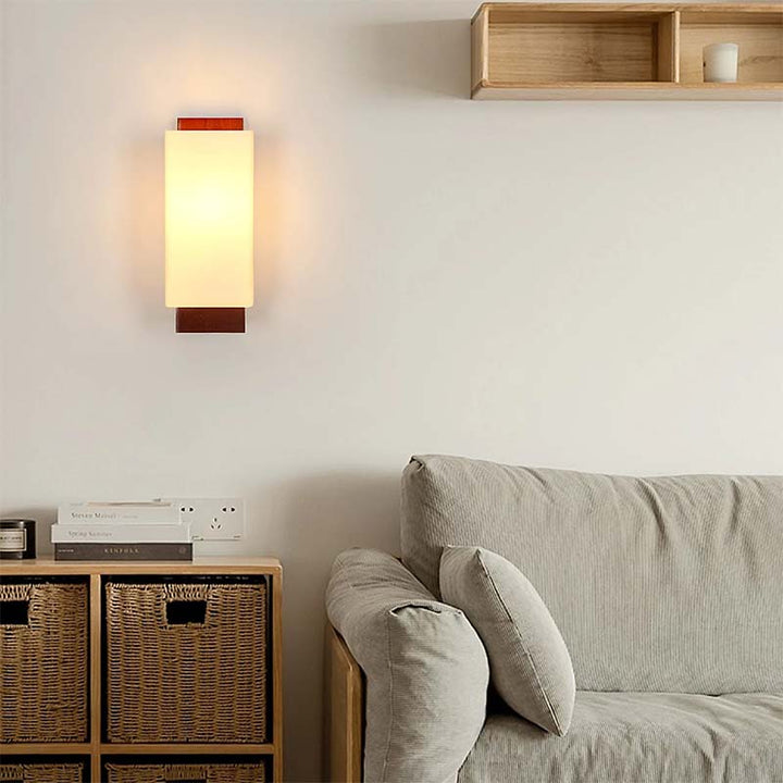 Modern living room with a nordic wall lamp, sofa, and storage unit.