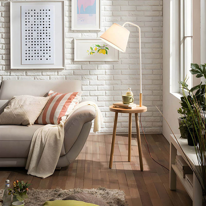 Floor lamp with tea table in living room, natural wood and cream linen shade, perfect for UK modern home décor.