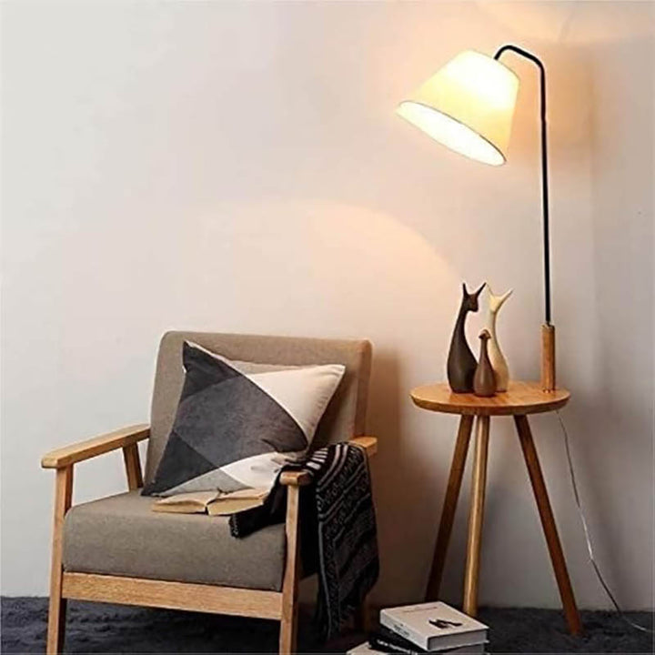 Nordic floor lamp with table next to the chair, warm ambient lighting and natural wood, ideal for UK reading nooks