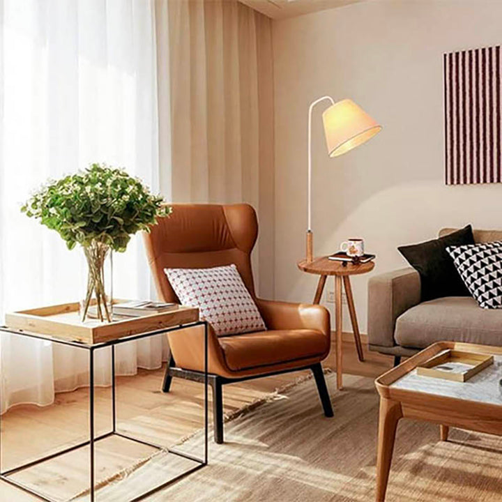 Nordic floor lamp with table next to sofa, warm ambient lighting and natural wood, ideal for UK living rooms