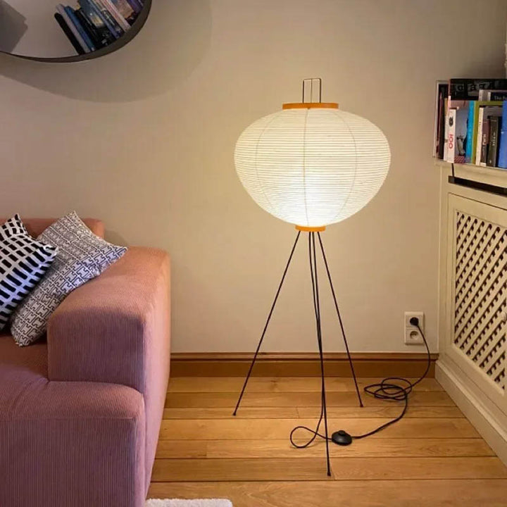 Soft-glow rice paper floor lamp styled beside pink sofa, perfect for Japandi-inspired living spaces.