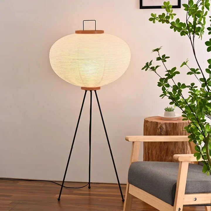 Rice paper Japandi floor lamp next to Nordic armchair, adding warmth and natural texture to interiors.